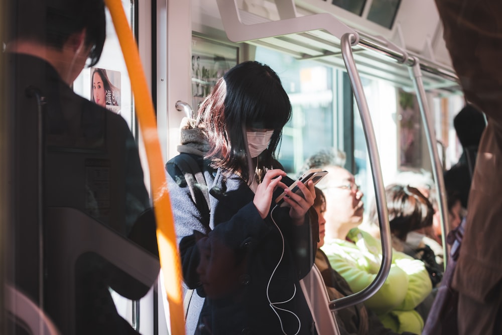 woman in black fur jacket using phone