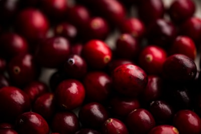 shallow focus photography of red berry lot cranberry google meet background