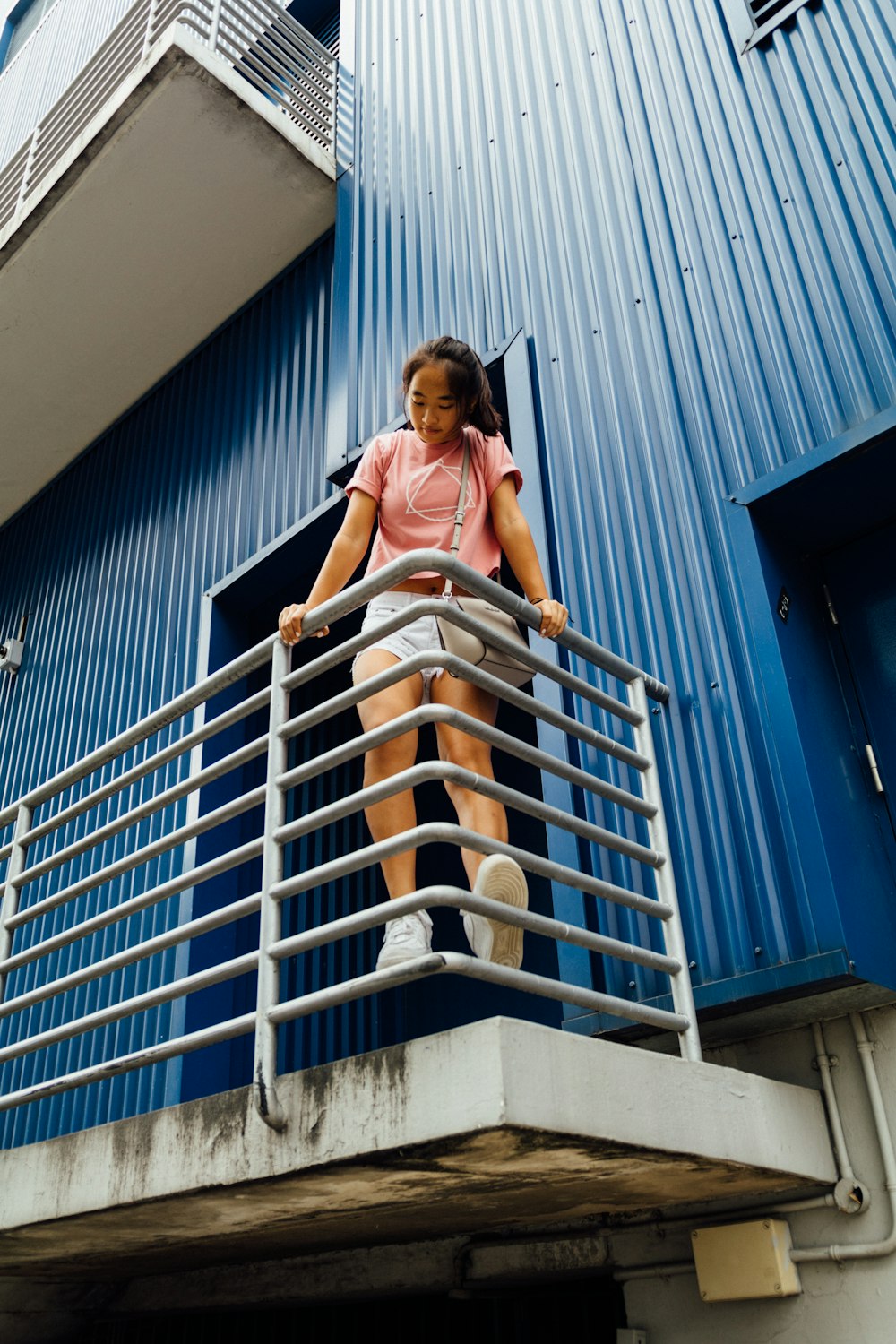 woman standing on gray railing