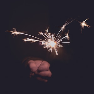 person holding sprinkler firecracker