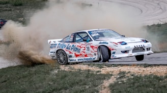 white and red stock car on road