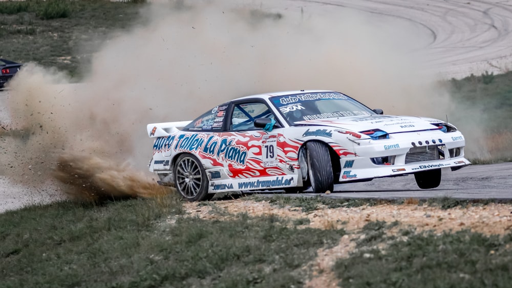 white and red stock car on road