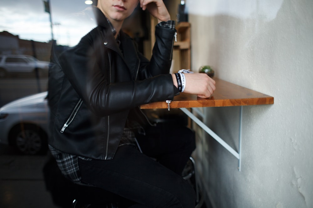 man wearing black leather jacket