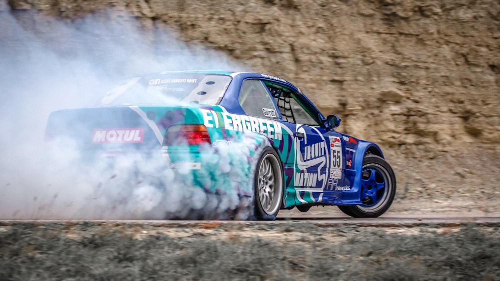 blue racing car on road during daytime