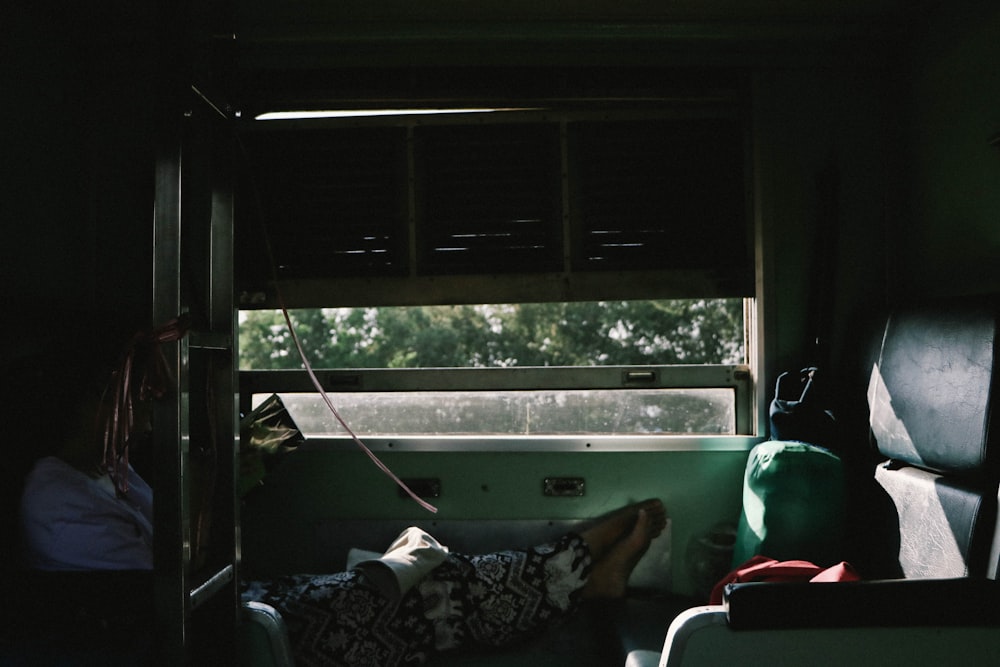 woman lying in bench