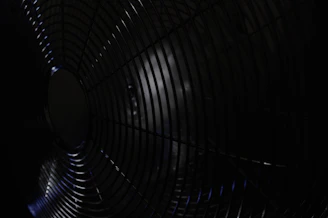 Close-up of a sleek black metal grill with precise welds and a matte finish.