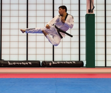 man doing karate stunts on gym