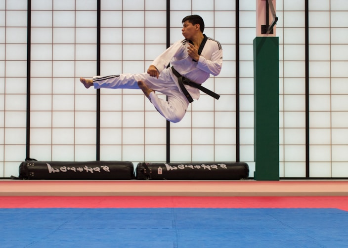 man doing karate stunts on gym