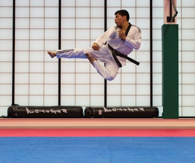 man doing karate stunts on gym