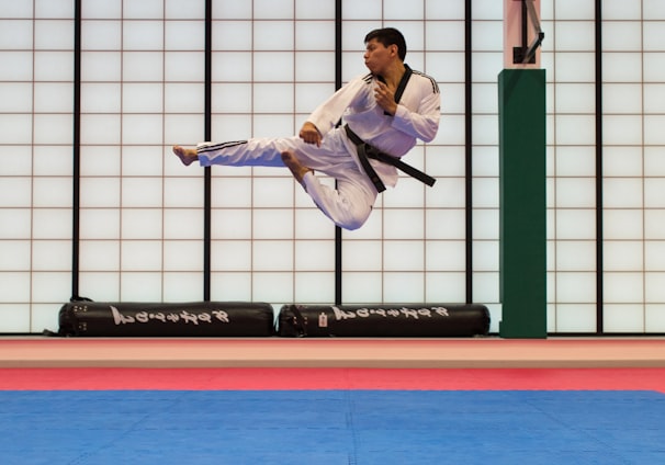 man doing karate stunts on gym