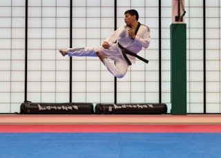 man doing karate stunts on gym