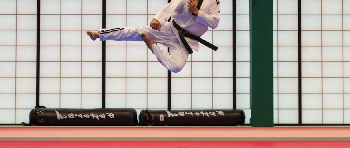 man doing karate stunts on gym