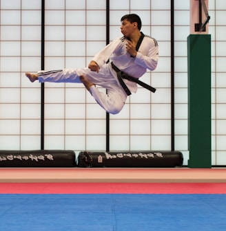 man doing karate stunts on gym