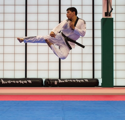 man doing karate stunts on gym