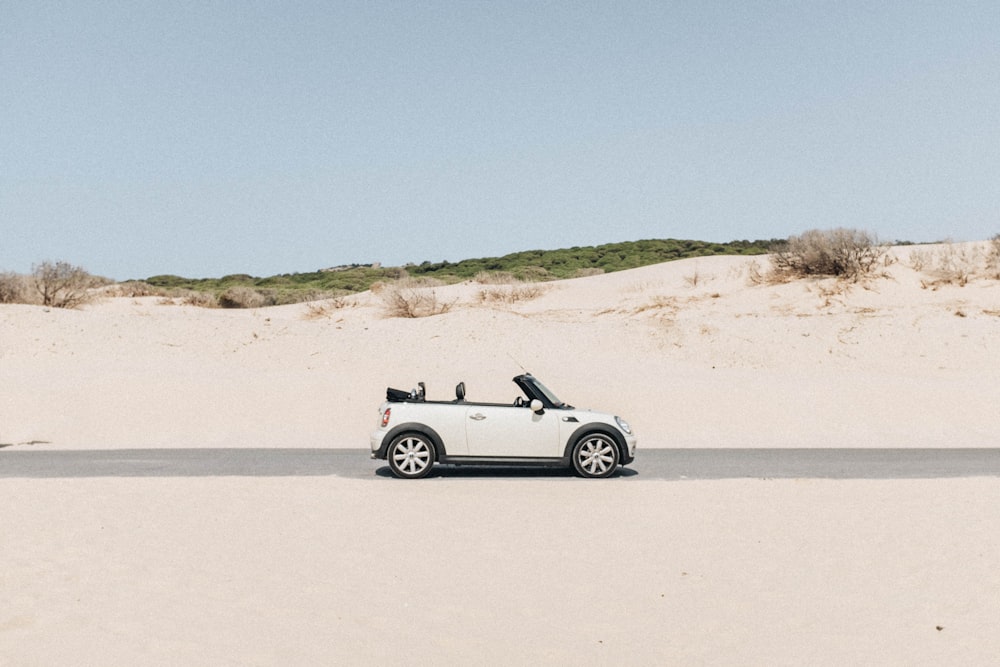 convertible coupe in middle of road