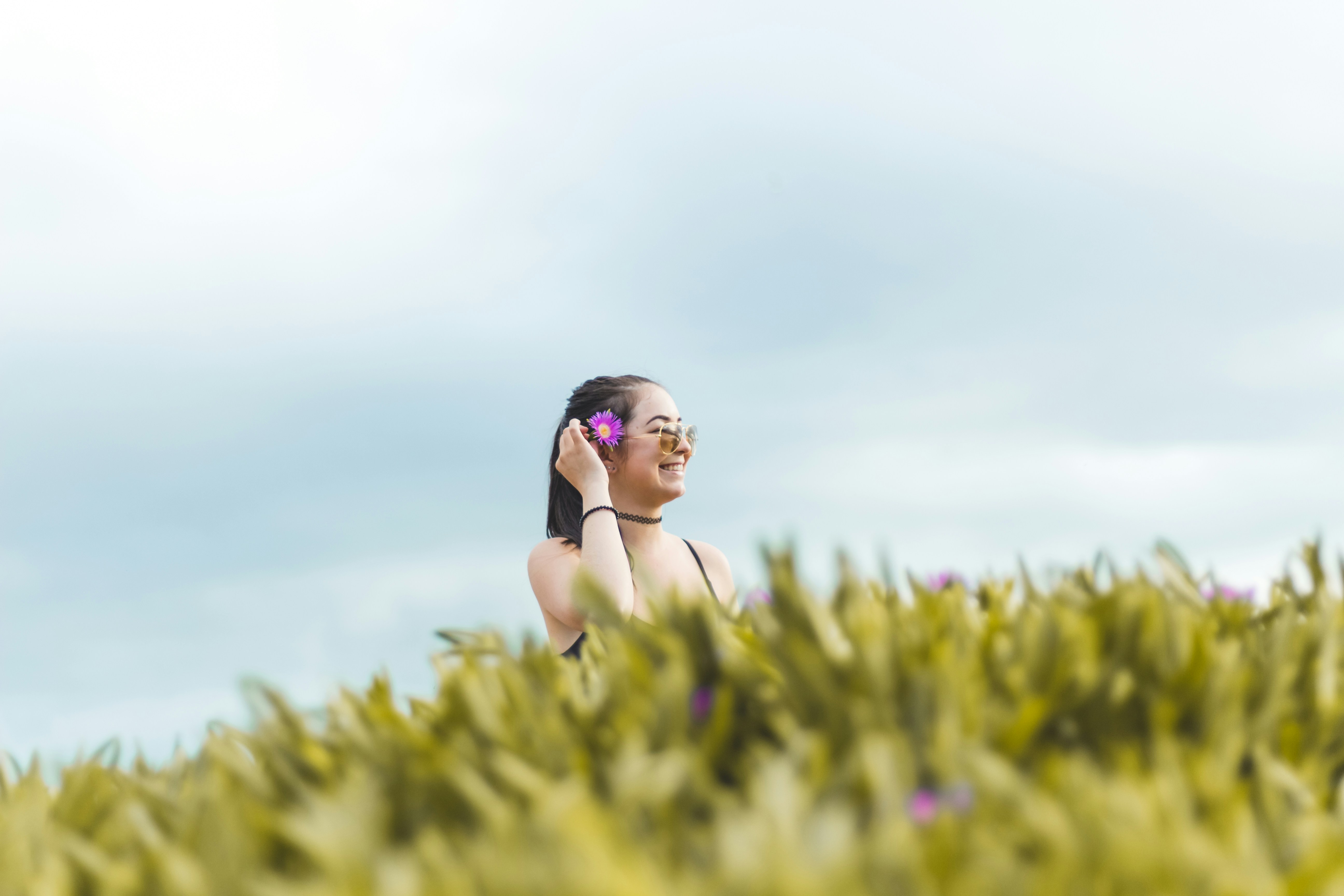 woman standing on grass field during daytime