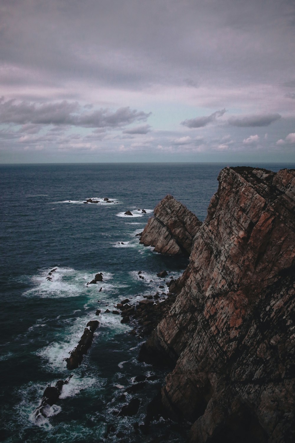 rock formation near the sea during daytime