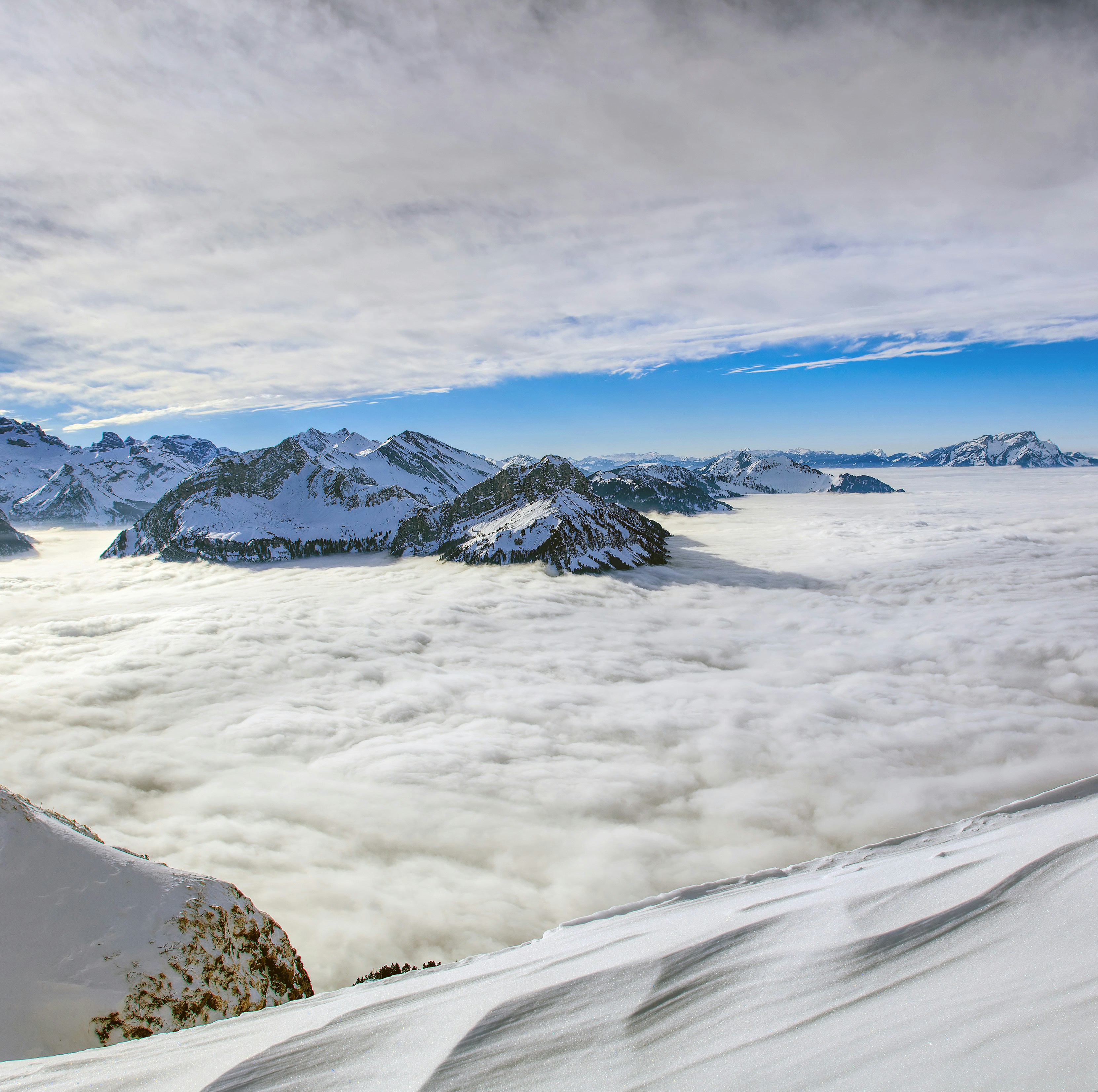 snow-capped mountain under white and blue sky