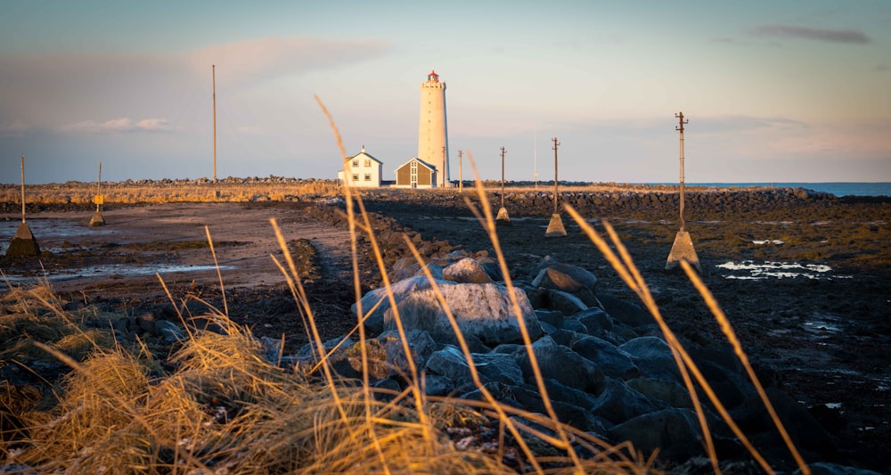 white lighthouse on brown field during daytime