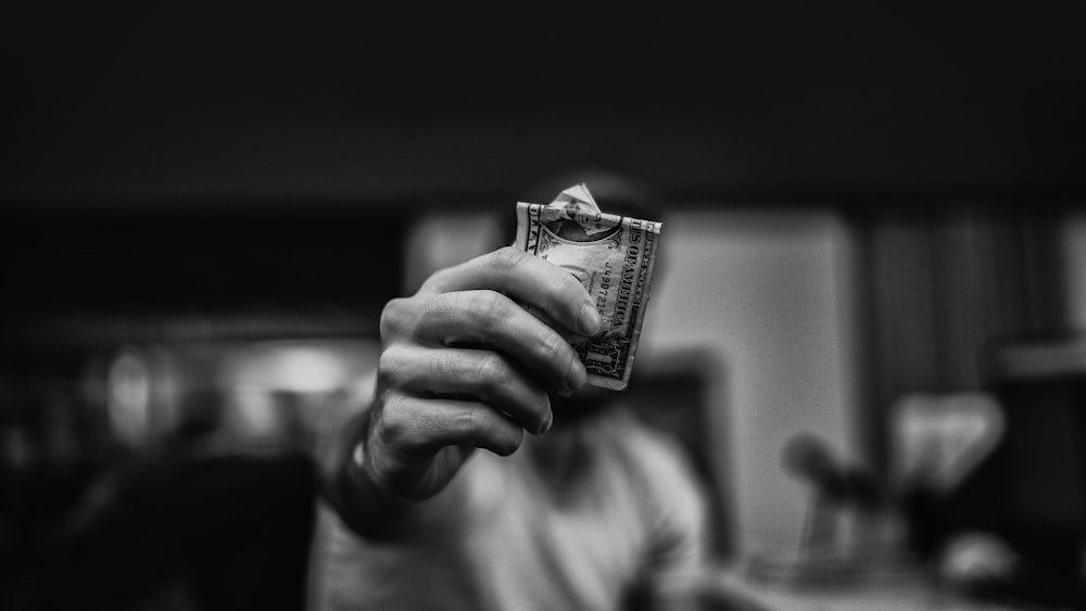 man holding 1 US dollar banknote