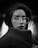 grayscale photo of woman wearing coat and eyeglasses