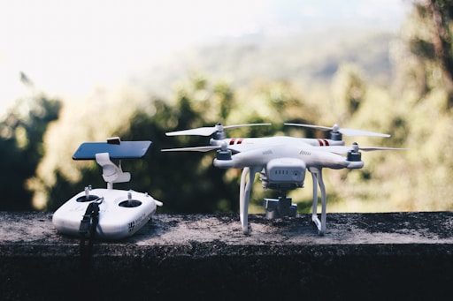 white quadcopter drone with remote