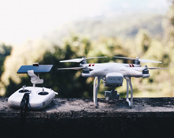 white quadcopter drone with remote