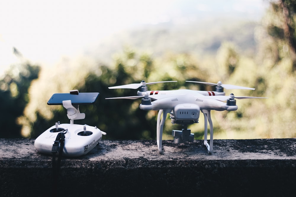 white quadcopter drone with remote