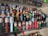 A collection of PEZ dispensers is displayed on a clear shelf, featuring a variety of character heads from popular culture, including superheroes, science fiction figures, and other recognizable characters.