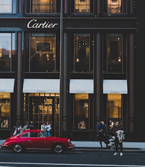 red coupe infront of cartier shop