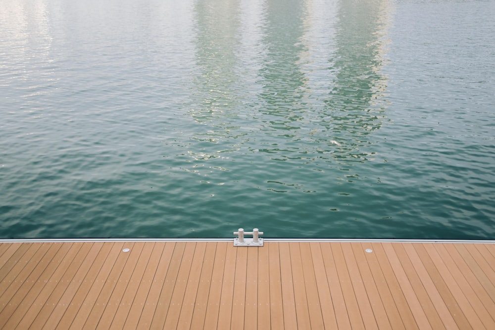 white and gray wooden dock on body of water during daytime