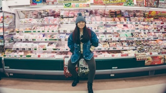 A shopper happily picking bundled products from a neatly arranged shelf.