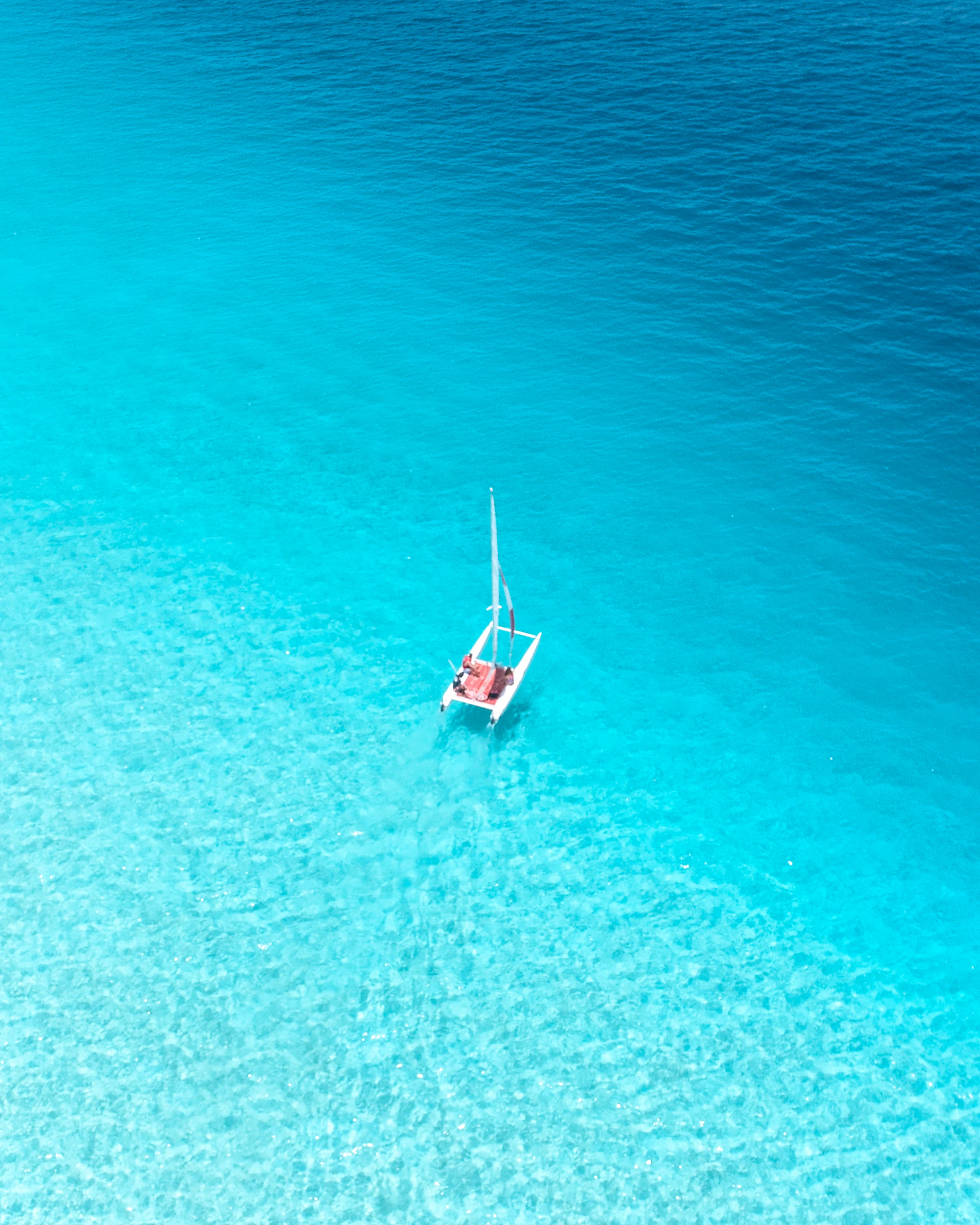 aerial view photography of sailboat on body of water