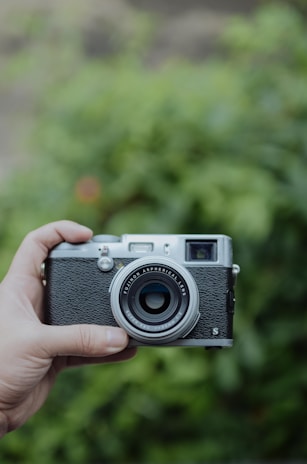 black and gray holding camera