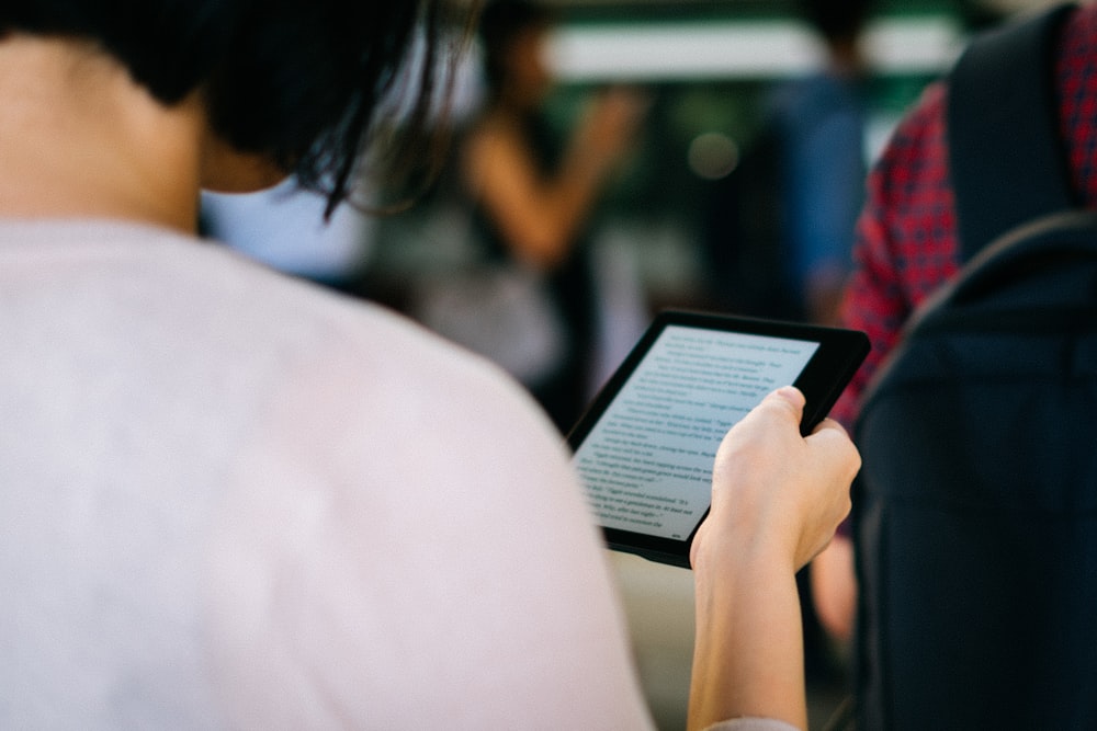 woman holding ebook reader