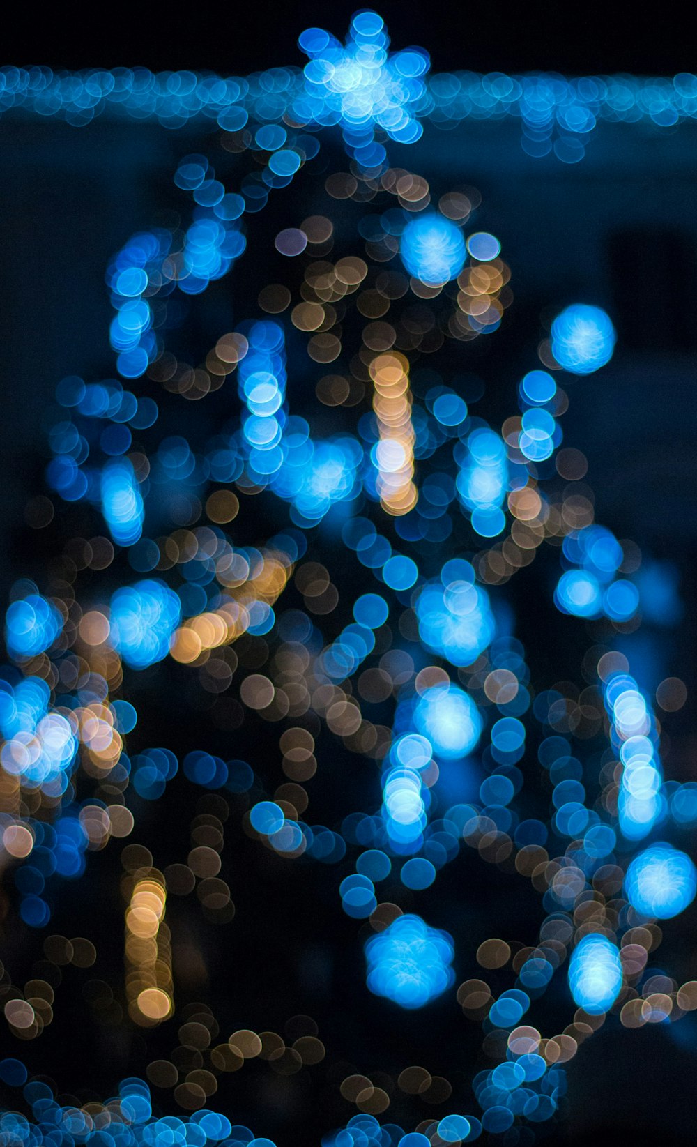 a blurry photo of a blue christmas tree