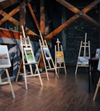 five assorted paintings on easels