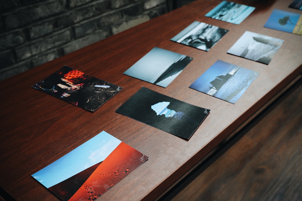 assorted posters on brown wooden table