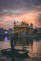 man riding on boat near golden mosque