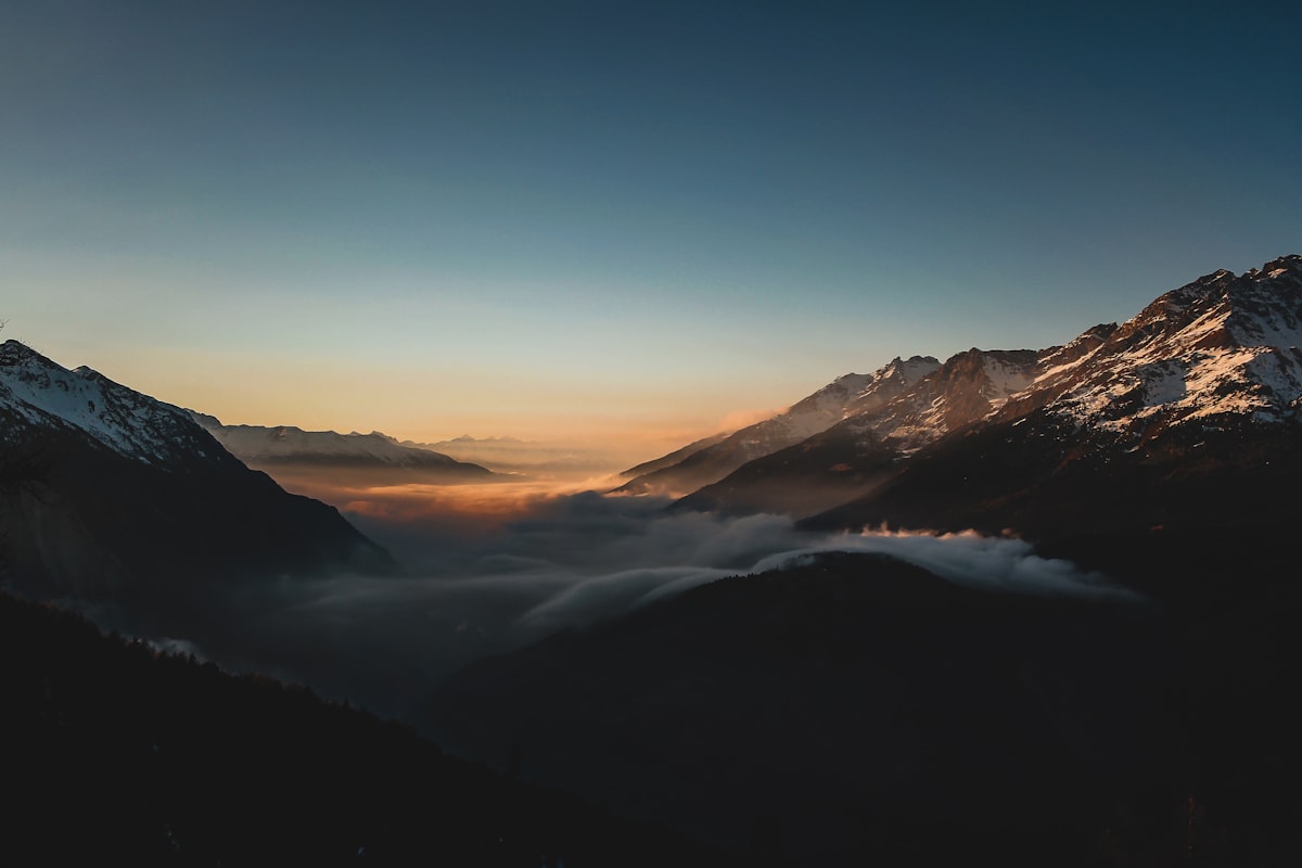 A serene lake reflecting the sky at dawn