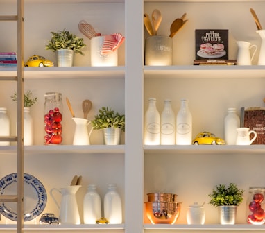 white ceramic bottles on shelf