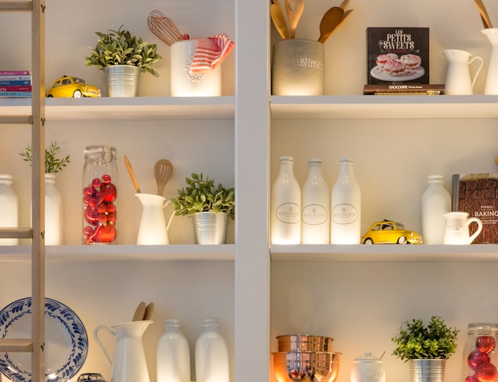 white ceramic bottles on shelf