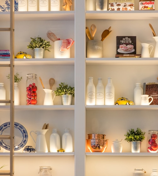 white ceramic bottles on shelf