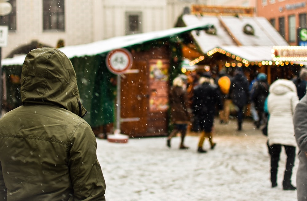 person wearing green hoodie on snow