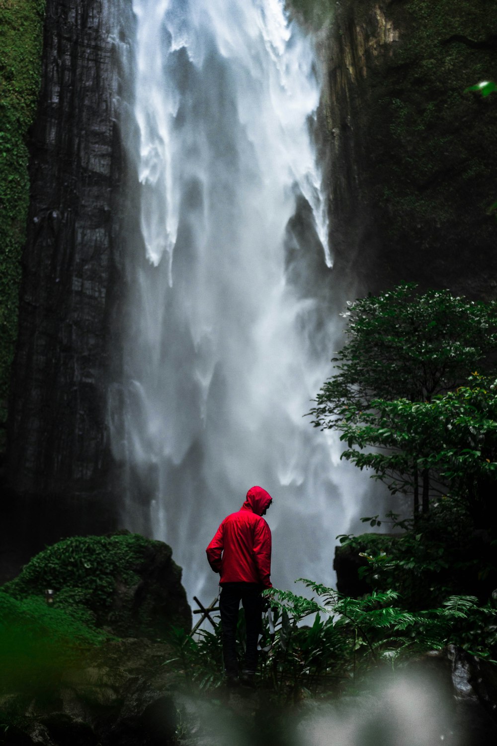 man standing in front of waterfalls