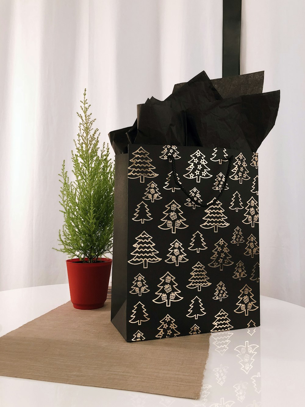 black and gray paper bag on table