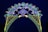 An illuminated arch constructed with numerous small lights forms a decorative pattern against a dark blue sky. The design includes floral and geometric shapes in green, blue, white, and yellow lights, with red flower-like bulbs scattered throughout.