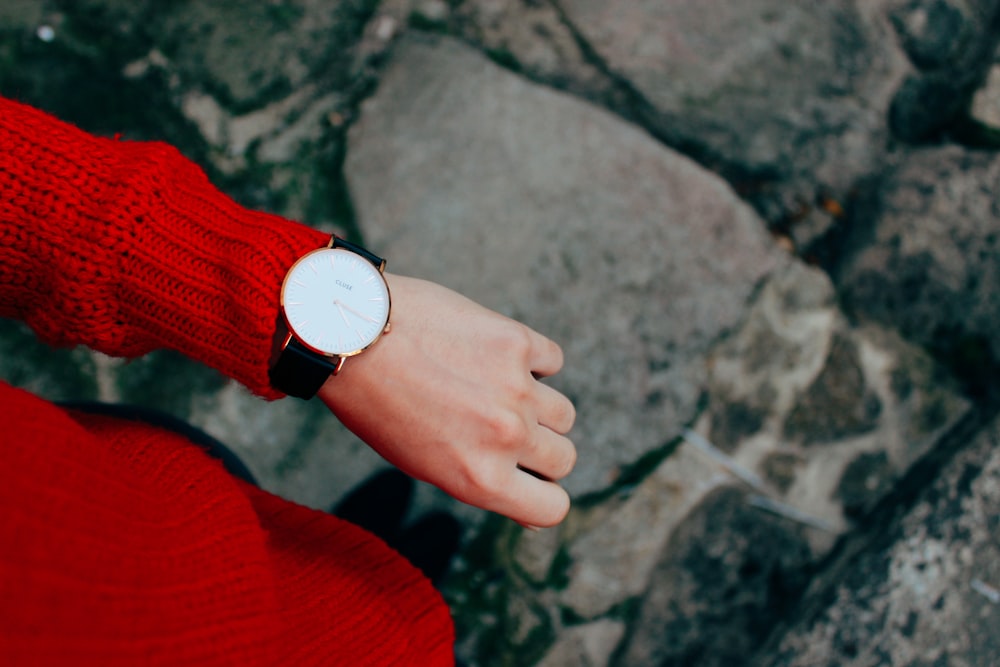 person wearing red sweater and watch