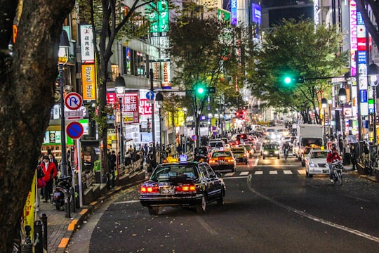 car in the middle of road in Shibuya Japan