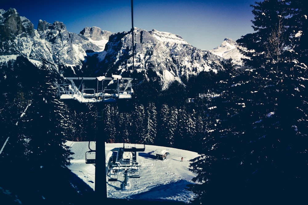 a ski lift going up a snowy mountain